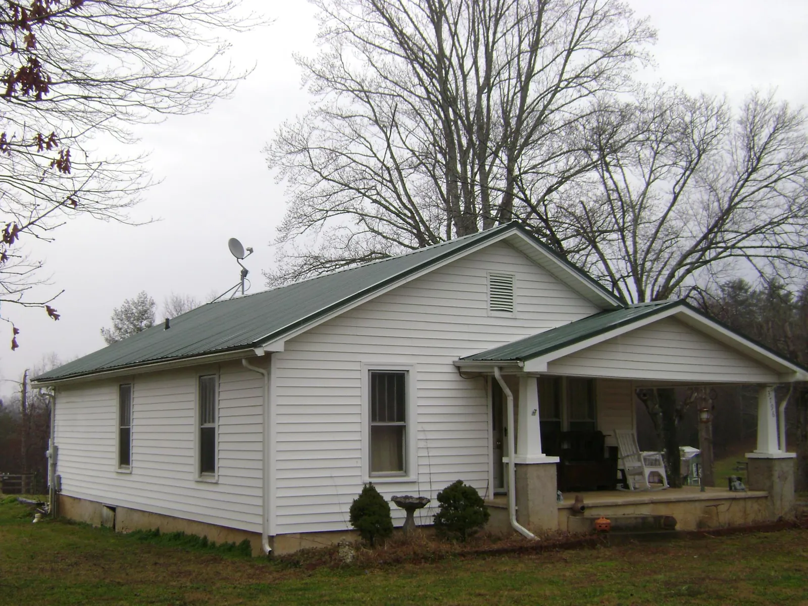 Green metal roof on a white bungalow with a side porch in Newcastle